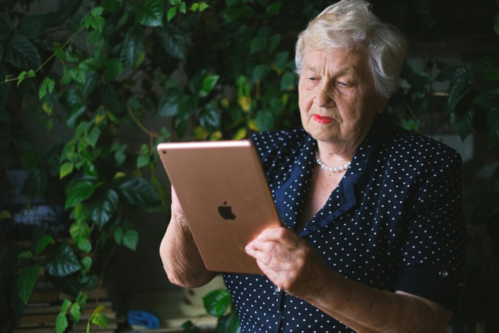 A woman in black on a tablet.